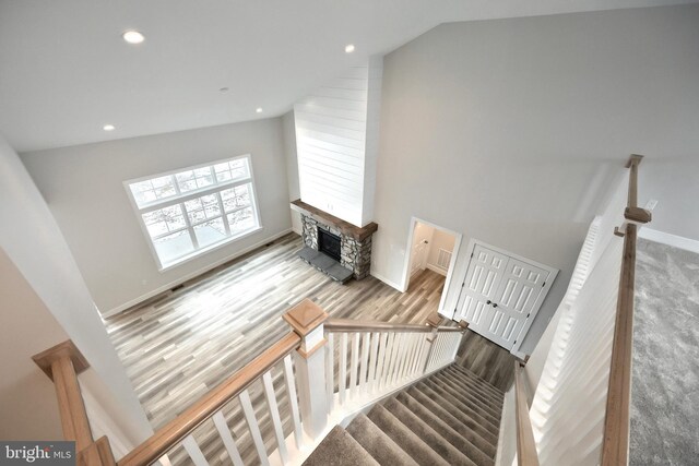 146 Wyndale Dr, Ephrata, PA 17522 - stairway with recessed lighting, vaulted ceiling, wood finished floors, a stone fireplace, and baseboards