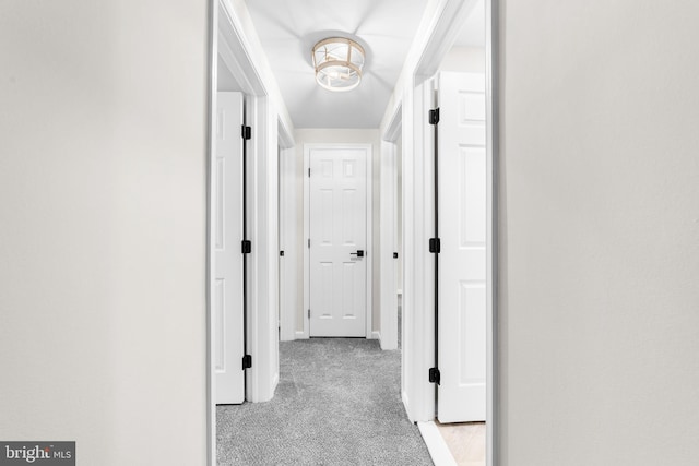 hallway with light carpet and baseboards