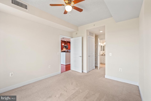 unfurnished bedroom with connected bathroom, carpet floors, visible vents, and baseboards