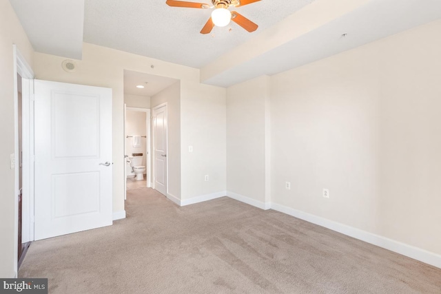 unfurnished bedroom featuring baseboards, carpet, and connected bathroom