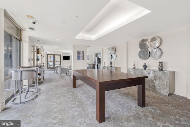 rec room featuring french doors, baseboards, visible vents, carpet, and a raised ceiling