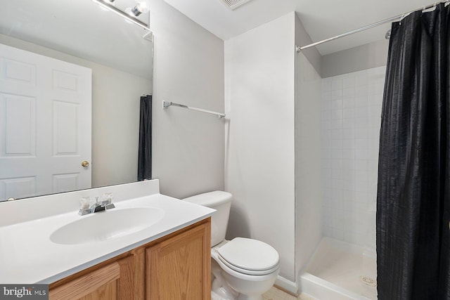bathroom featuring vanity, a stall shower, and toilet