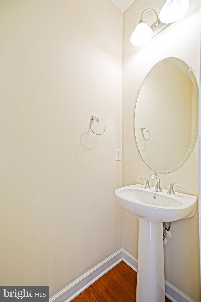 bathroom featuring baseboards and wood finished floors