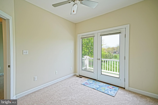 entryway with carpet flooring, a ceiling fan, baseboards, and french doors