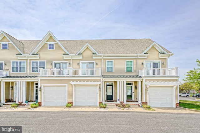 view of front of house featuring a porch, a shingled roof, a balcony, and a garage