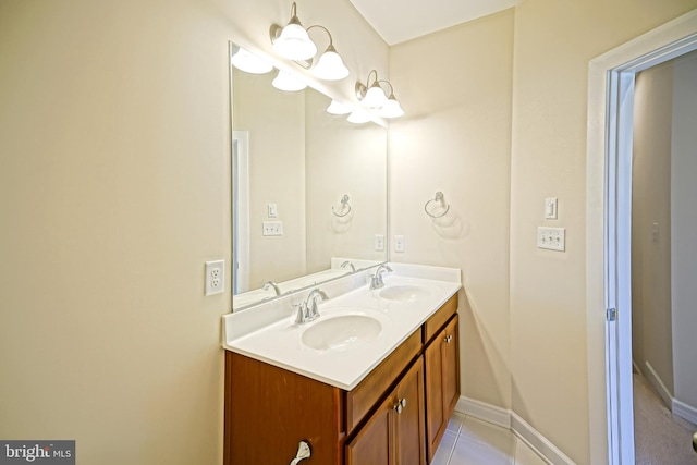 full bathroom featuring double vanity, a sink, and baseboards