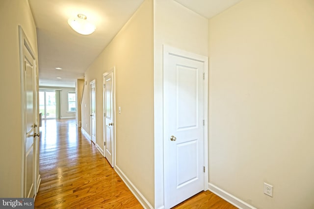 hall featuring baseboards and wood finished floors