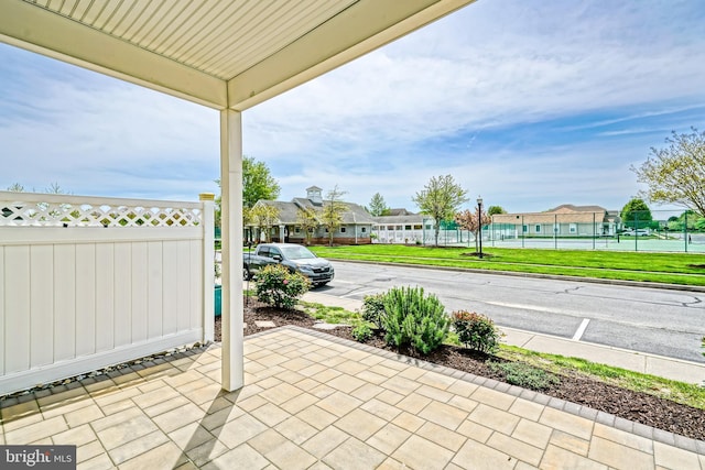 view of patio with fence and a residential view