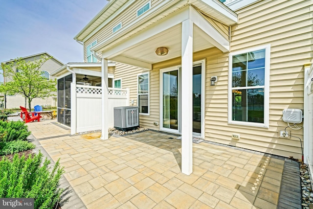 view of patio / terrace with ceiling fan, fence, and cooling unit