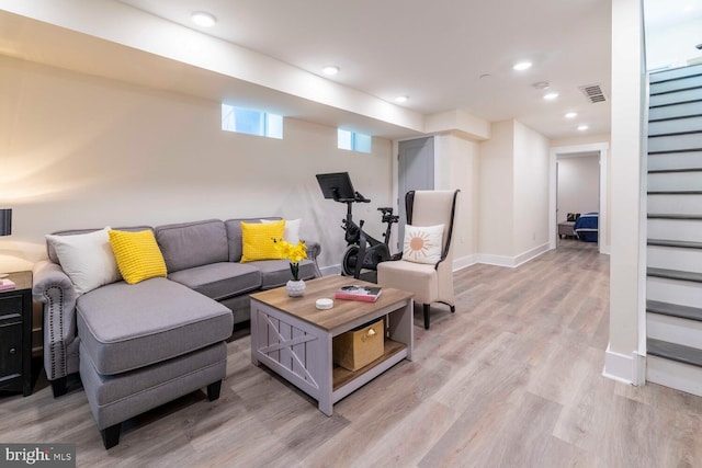 living area featuring baseboards, recessed lighting, visible vents, light wood-style floors, and stairs