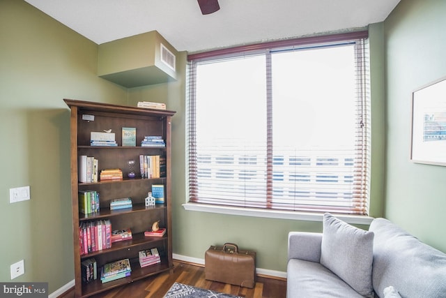 living area featuring dark wood finished floors and baseboards