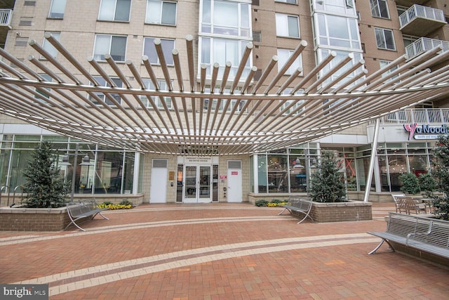 view of exterior entry featuring brick siding
