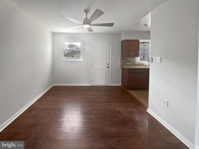 2115 Greenwood Dr, Waldorf, MD 20601 - unfurnished dining area featuring dark wood-type flooring, baseboards, and a ceiling fan