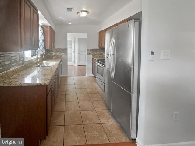 2115 Greenwood Dr, Waldorf, MD 20601 - kitchen with light tile patterned floors, visible vents, decorative backsplash, stainless steel appliances, and a sink