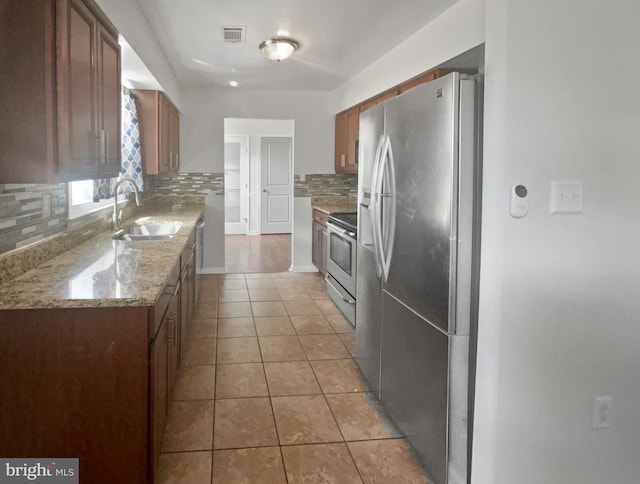 2115 Greenwood Dr, Waldorf, MD 20601 - kitchen featuring visible vents, light tile patterned floors, a sink, stainless steel appliances, and backsplash