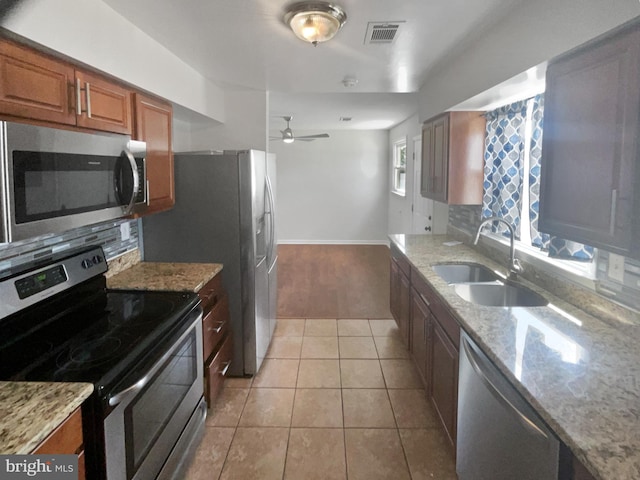 2115 Greenwood Dr, Waldorf, MD 20601 - kitchen with brown cabinetry, tasteful backsplash, visible vents, a sink, and stainless steel appliances