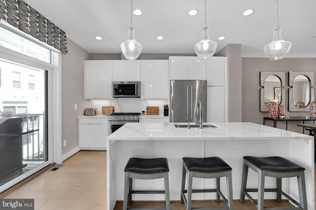 kitchen featuring a sink, modern cabinets, white cabinets, and stainless steel appliances