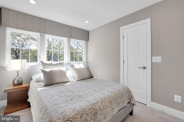 carpeted bedroom featuring baseboards and recessed lighting