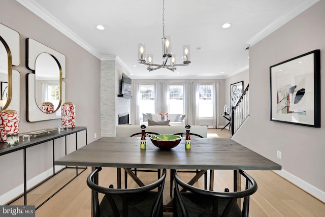 dining area with ornamental molding, recessed lighting, a chandelier, and light wood finished floors