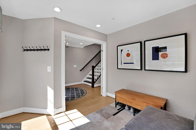 interior space with baseboards, recessed lighting, wood finished floors, and stairs