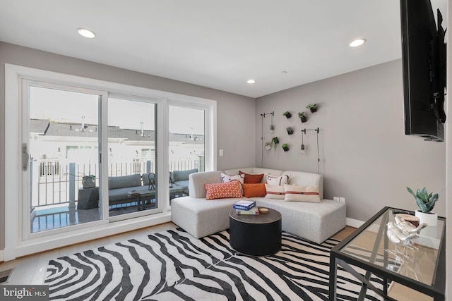 living area with recessed lighting and wood finished floors