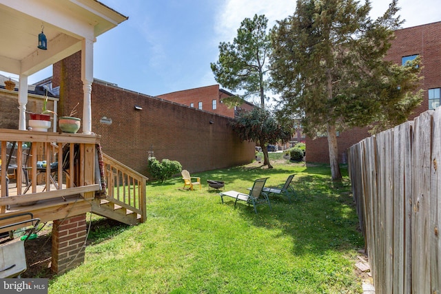 view of yard featuring fence and stairs