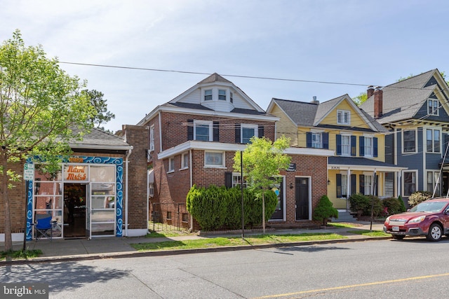 view of property featuring brick siding