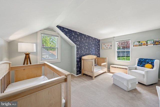 carpeted bedroom with vaulted ceiling and wallpapered walls