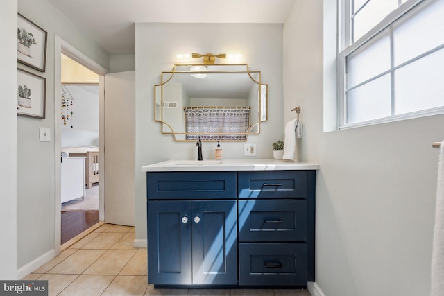 bathroom featuring baseboards, tile patterned floors, and vanity