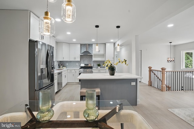 4403 Echo Ct, Woodbridge, VA 22193 - kitchen featuring appliances with stainless steel finishes, wall chimney exhaust hood, a sink, backsplash, and light countertops