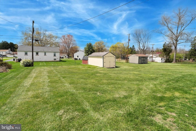 view of yard featuring an outdoor structure and a storage shed