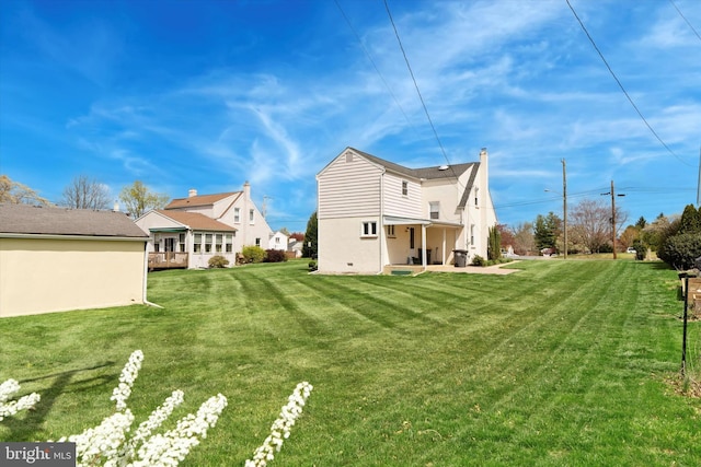 rear view of house featuring a lawn