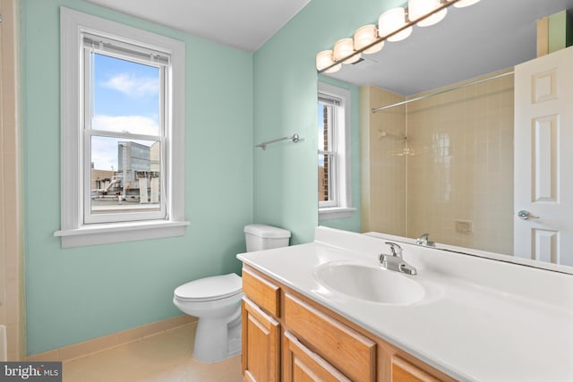 full bath with toilet, a healthy amount of sunlight, vanity, and baseboards
