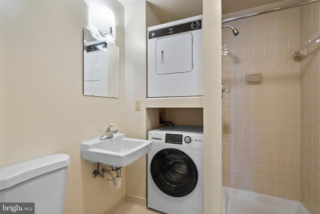 washroom with stacked washer and dryer and laundry area