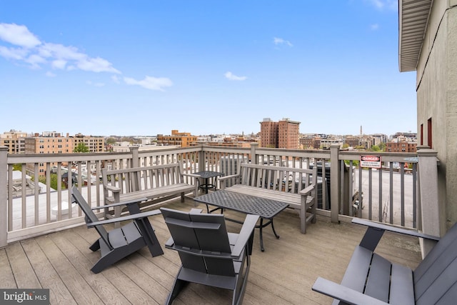 wooden terrace featuring a city view