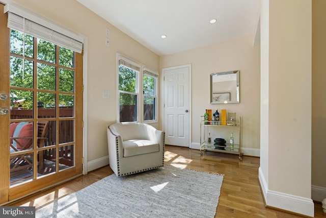 sitting room featuring baseboards, recessed lighting, and wood finished floors