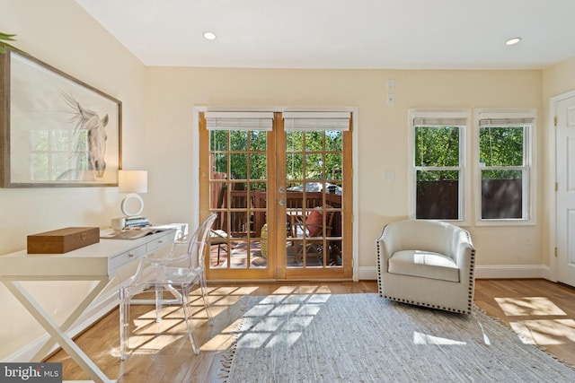 sitting room with an office area, wood finished floors, baseboards, and recessed lighting