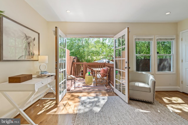 doorway to outside featuring wood finished floors, plenty of natural light, french doors, and recessed lighting