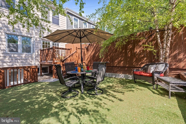 view of yard with a wooden deck and a patio