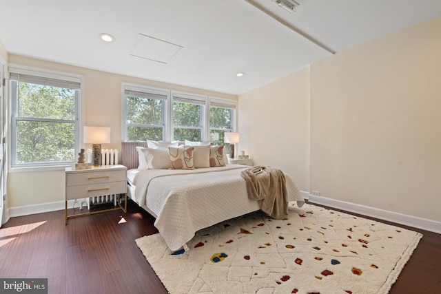 bedroom featuring baseboards, multiple windows, wood finished floors, and recessed lighting