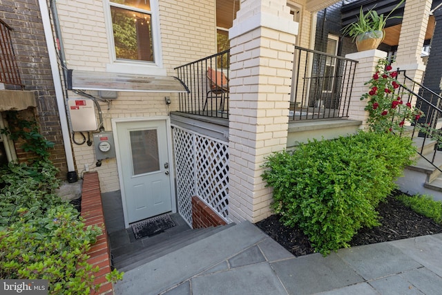 entrance to property featuring brick siding