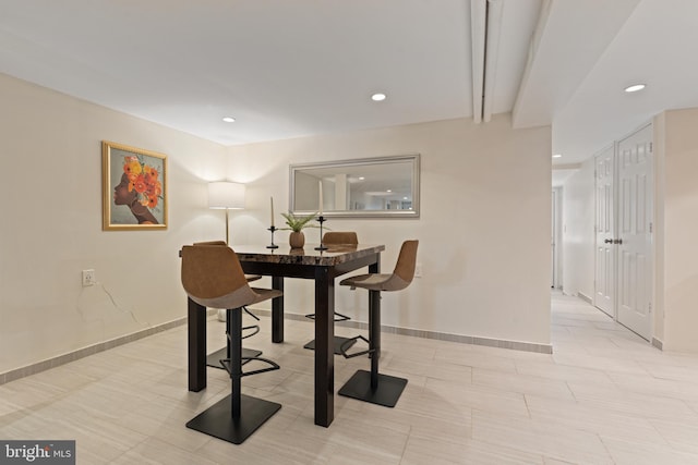 dining space featuring recessed lighting and baseboards