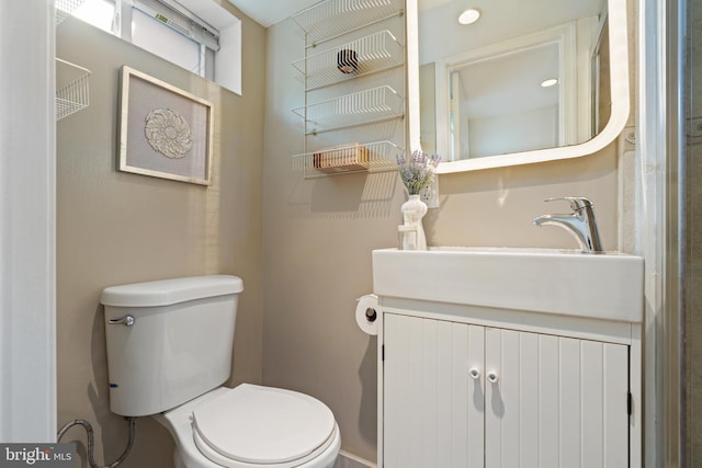 bathroom with toilet and vanity
