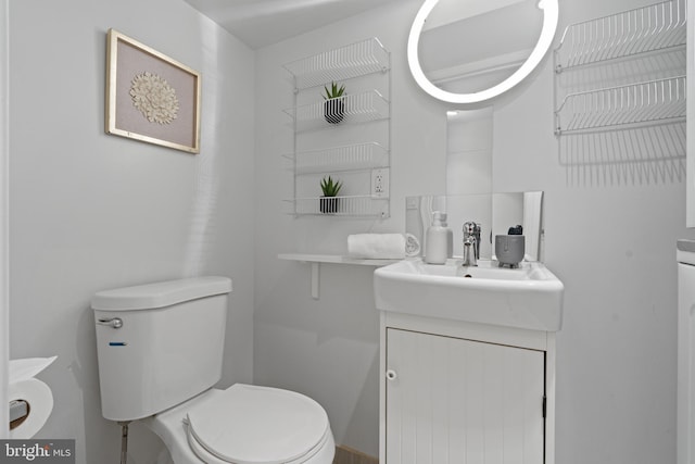 half bathroom featuring toilet and vanity