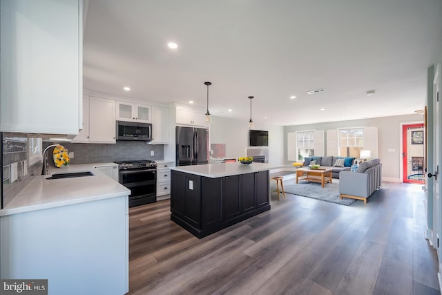 16 S Union St, Lambertville, NJ 08530 - kitchen featuring light countertops, white cabinetry, appliances with stainless steel finishes, a sink, and wood finished floors