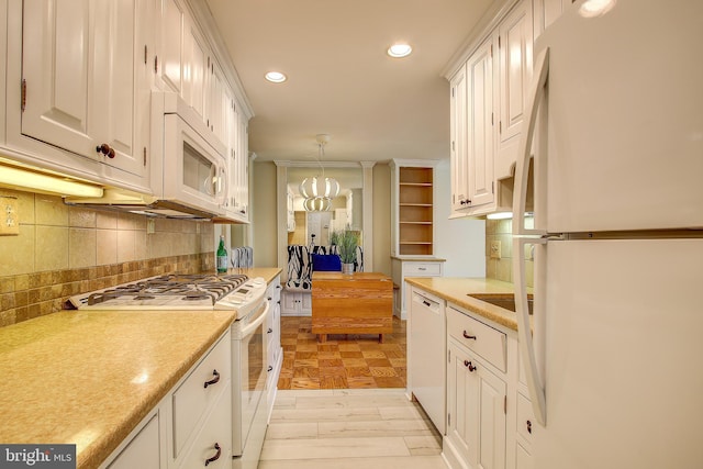 kitchen featuring light countertops, white cabinets, and white appliances