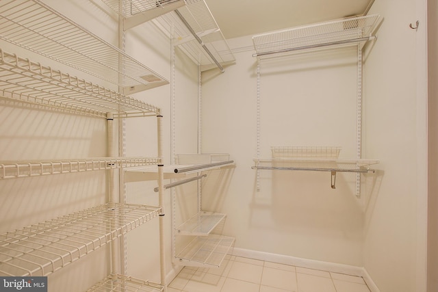 walk in closet featuring light tile patterned flooring