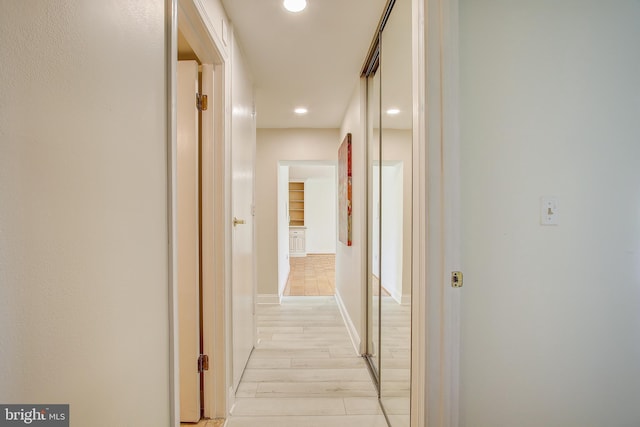 hall with recessed lighting and light wood finished floors