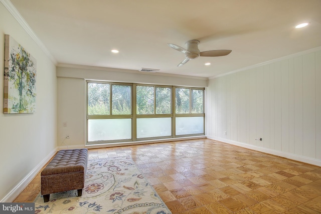 unfurnished room featuring crown molding, baseboards, ceiling fan, and visible vents