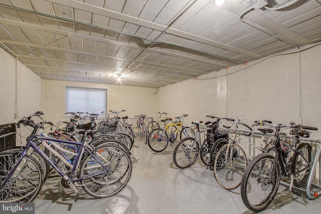 garage featuring concrete block wall and bike storage